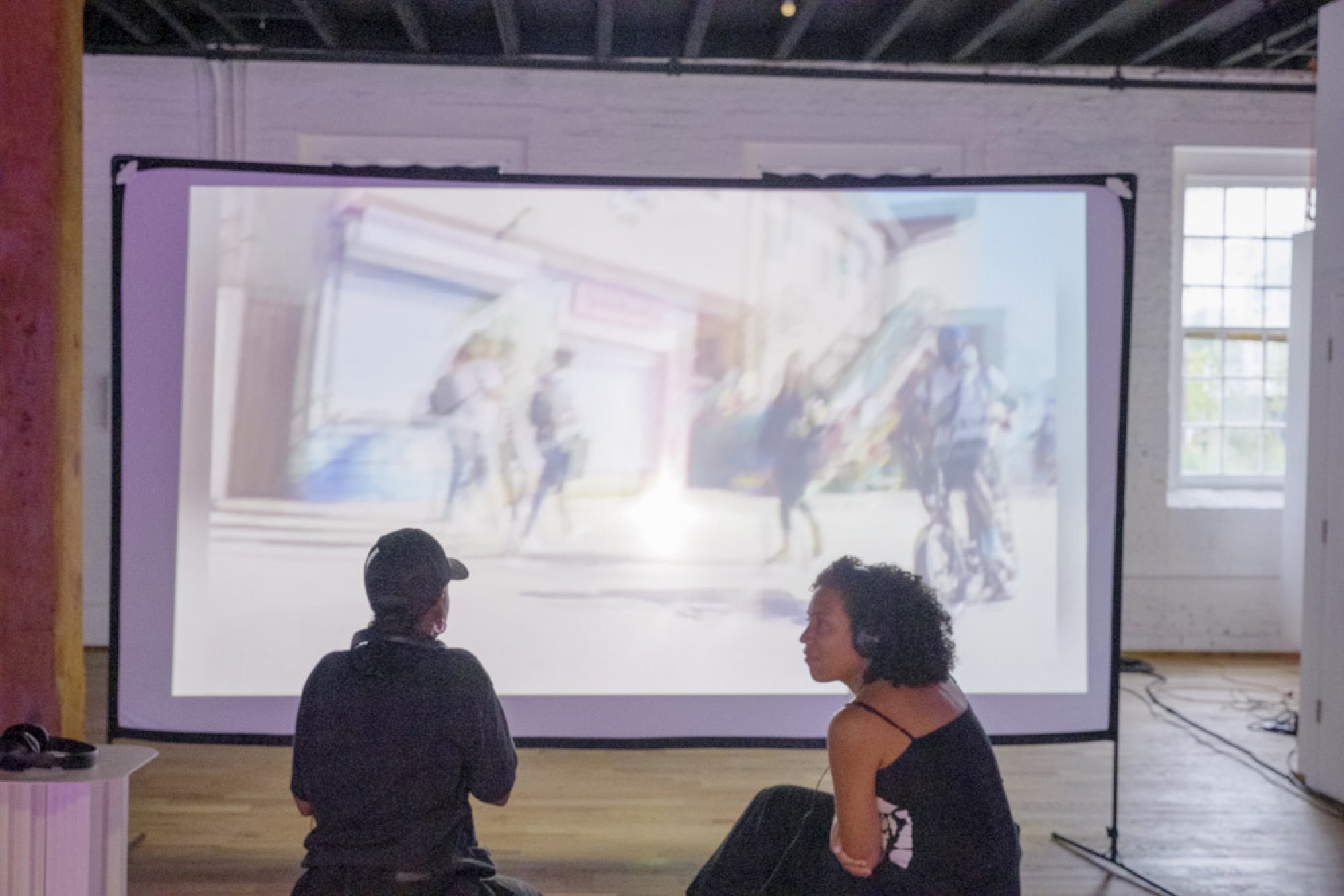 AVC Fest installation: visitors approaching the angled-glass cabinet